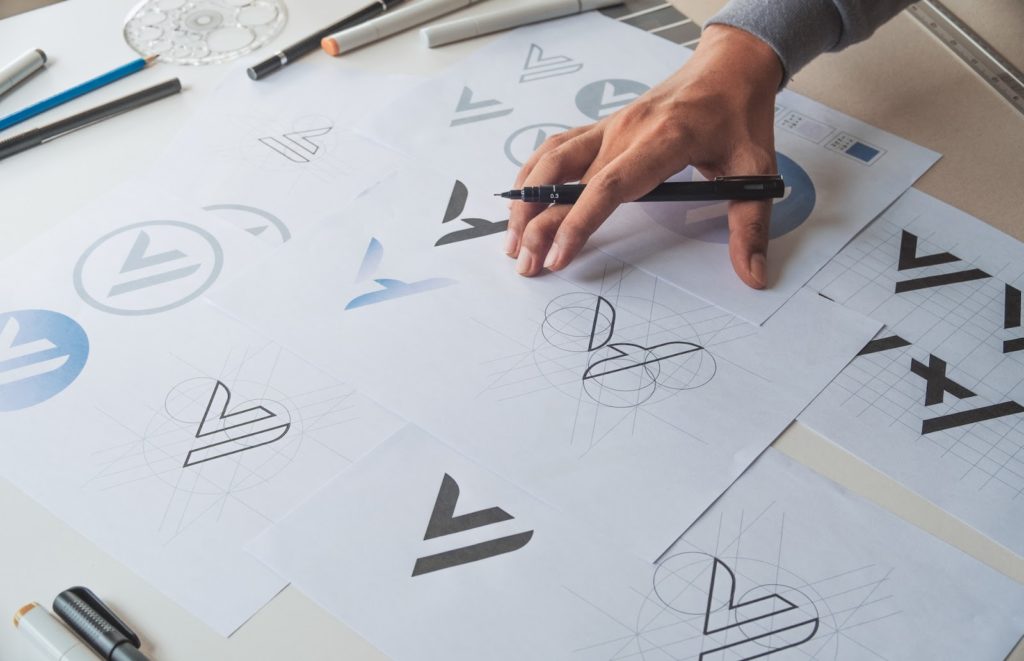 A graphic designer looking at a variety of logos for a new company.