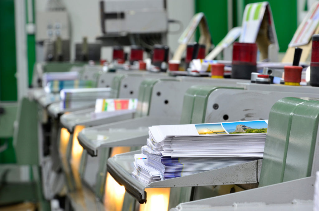 A row of printers in a print shop in El Paso.