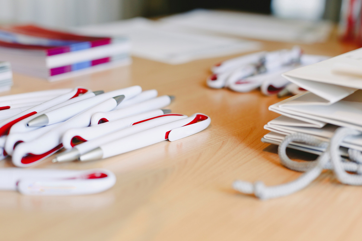 Red and white pens and white bags on a table in El Paso.